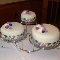 Nana's 80Th All cakes were of different flavors but covered in vanilla bc and covered with MMF. Royal icing flowers (colors pulled from the ribbon...