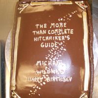 Hitchhiker's Guide To The Galaxy My husbands favorite book! I meant to airbrush the ganache black, but I had half of the lettering on when I realized I hadn't! The...
