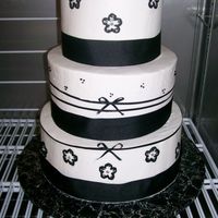 Black Bows A wedding cake with black ribbon and brushed flowers