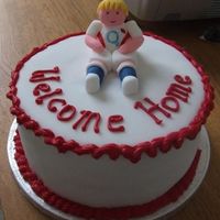 Welcome Home England A cake to welcome my brother home from the Rugby World Cup, the fugure is fondant and the accents in royal icing.