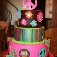 Hippie Chick Birthday Cake buttercream tiered cake with edible wrap on second tier and various gumpast accents, some with edible images applied. This was designed to...