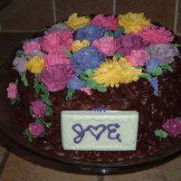 Bridal Shower Cake The theme of course was flowers...the cake is a vanilla buttercake with fresh strawberries.. the icing is chocolate icing.. the flowers are...