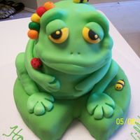 Froggy Birthday With Bugs I based this design on the cake from 50 Easy Party Cakes, but used a ball cake for the body. He is sitting on a chocolate cake lily pad....