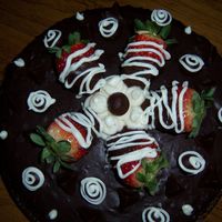 Strawberry & Chocolate chocolate cake with buttercream frosting and sliced strawberries in the middle. chocolate ganache and chocolate covered strawberries on top...