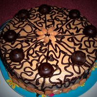 100_2425.jpg Layered banana cake with sliced bananas and chocolate-caramel frosting. Chocolate cornelli lace, hand-make almond-filled chocolate truffles...