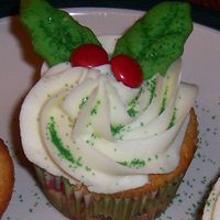119809694893770.jpg orange-cranberry cupcakes, lemon frosting, cookie holly leaves and red candy covered chocolates.