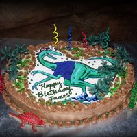 Edible Image Dino Chocolate oatmeal cake with chocolate buttercream icing. Last minute order asking for a dinosaur birthday theme for a 4-year-0ld boy. Found...