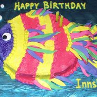 Fishy Birthday Brightly colored buttercream covered carved oval sheetcake. Fondant strips for fins, eyeball, and bubbles. Fresh banana cake with vanilla...