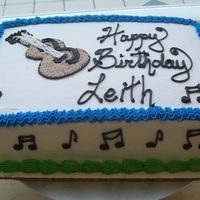 100_0847.jpg I freehanded the guitar on this cake with chocolate fudge frosting, then I star tipped the color inside of it. I think it came out pretty...