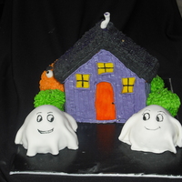 Haunted House wilton stand up house pan, mini doll pan for ghosts and monster in background. house is all bc, fondant covered ghosts. for 6 year old girl...