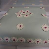Square Fondant Daisy This is a 10 inch square cake covered with aqua fondant and decorated with magenta Royal daisies.