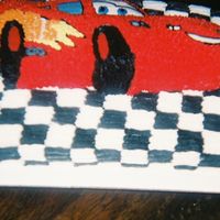 Lightening Mcqueen Cake lightening mcqueen with checker board background all in bc.