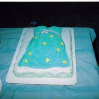 Belly Cake used a football pan and cupcakes to create front . butter cream frosting with fondant daisies.