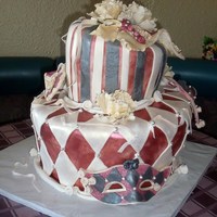 Mardi Gras Whimsical Masks Peony Flower Wedding Cake This cake is two tiered, each tier has 3 cake layers. Bottom tier was 14 inch, top tier was 10 inch. Masks and Peony flowers are edible and...