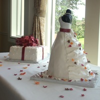 Bridal Shower Dress Cake Or Bridal Dress Cake With Autumn Or Fall Leaves And Edible Pearls; And Matching Present Cake Bridal shower dress cake is 4 round cake layers (one 10 inch, two 8 inch, one 6 inch) and bodice is black fondant covered rice krispy...