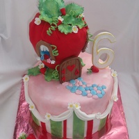 Strawberry Shortcake Theme House Cake strawberry house is red fondant covered rice krispy treats. All decorations are handmade, edible gumpaste or half gumpaste/half fondant.