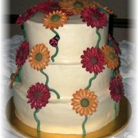 Fondant/gumpaste Gerbera Daisy Cake I was so worried about how these flowers would attach to the cake. But it all turned out ok. EXCEPT....I only charged the bride $50 for the...
