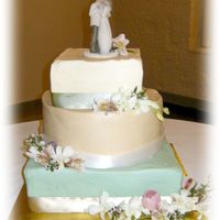 Green, Sage And Ivory Originally this was to be all 3 tiers square, offset but the groom wanted the middle one round. He also suggested the icing colors. We were...
