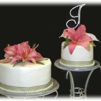 Sage And White With Pink Lillies This is the cake for my best friends wedding. The lillies are silk. Icing is buttercream.