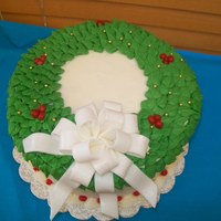 Christmas Wreath All cream cheese icing with a fondant bow dusted with luster dust.