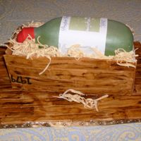 Wine Bottle Crate Cake is carved and stacked and covered in fondant. Wood crate is handpainted. Label is edible image.