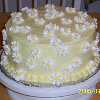 Sunshine And Daisies White Cake iced in buttercream. Flowers are royal icing. It's a variation on one of the cakes in Wilton Course 1