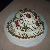 Three Tier Strawberry Heart Cake bottom layer choc, othre layers white. b.c icing and choc covered strawberries around bottom layer. drizzled melted choc all on top