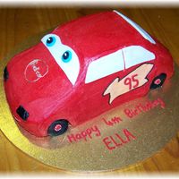 Lightning Mcqueen choc cake with bc icing and fondant accents. The red icing went a bit funny as it dried, like spotty, I wont use powder again I will use a...