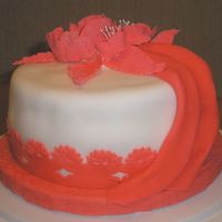 Red Flowers This was my Wilton fondant class cake. I used a clay mold set to make the flowers above the trim.