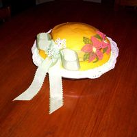 Summer Hat Yellow cake covered with a buttercream icing. I made the flowers in a cake decorating class - the icing was done on tulle cut into petal...
