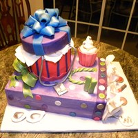 Birthday Gift Bag And Gift Box Two tier cake with fondant accents.