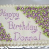 Purple Flowered Birthday Simple cake, filled with pineapple custard and iced with almond buttercream