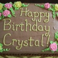 Chocolate And Pastel Roses Simple birthday cake, iced in chocolate buttercream with regular buttercream decorations.