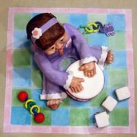 Baby At Play Everything is edible. Baby is sculpted and covered in Fondant. Blocks are also cake covered in Fondant. Toys & Quilt are Fondant.
