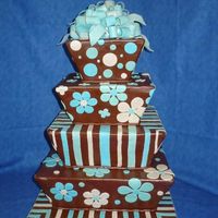 Tapered Squares Tapered square cakes covered in brown fondant and decorated with sky blue, turquoise, and ivory. The bow is marbled with the three colors I...