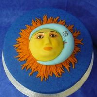 Sun & Moon Sun and moon are made from fondant and placed on a 12in round cake iced in blue then sponge painted with blue airbrush color.