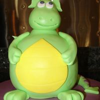 Cute Dragon Chocolate cake butter cream filling. Covered in fondant to make it look like a dragon. I am donating this cake to my children's school...