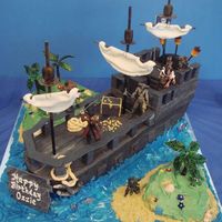 Pirates Ship Pirates of the Carribean. Ship was sculpted and covered in fondant then embellished with various sugar miniatures.