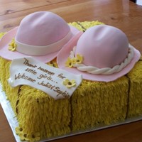 Twin Baby Shower Made for a mother of twin girls who has a farm. Cowboy hats on a hay bale.