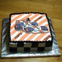 Formula 1 Birthday Fench vanilla cake with buttercream filling, covered in MMF with FBC transfer of car.