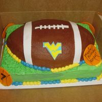 Wvu Football Football pan on 9"x13". Fondant WV, accents on football, and basketballs. Everything else is BC.