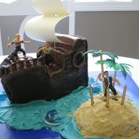 Pirate Ship Birthday Cake Chocolate cake (mix) baked in a 9x11 pan. I cut it into thirds, then stacked and carved it to make the ship-shape.Filled with chocolate...