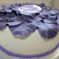 Purple Flower Birthday Cake Vanilla cake covered with buttercream Petals were made out of fondant and placed on the cake after they were partially dried. writing was...