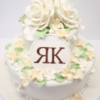 2 T Wedding Cake In White & Cream 2 T wedding cake, decorated withgum paste roses, hydrangeas, primrose flowers, pearls, rose petals and leaves. TFL!