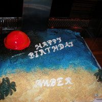 Sunset buttercream icing, blue crystal candies, graham cracker crumbs, airbrushed fondandt sun