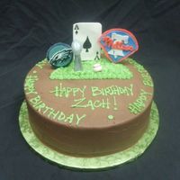 Philadelphia Sports Fanatic 10 round. Chocolate buttercream with Gumpaste sports memorabilia. Phillies, Eagles, Lombardi Trophy, Baseball and Ace of Spades card...