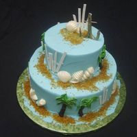 Beach Fun cake is a 10 6 round. buttercream with sanding sugar for sand, buttercream palm trees, gumpaste anchor and beach fence and white chocolate...