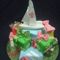 Gift Tower With Sugar Sail Boat Bride was from Louisiana so that explains the Fleur de Lis motif. Groom races sailboats. This was a sugar replica of the Melges 24 he races...