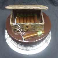 Cigar Cake For Cigar Loving Couple Groom loves cigars. Cake is a 10 inch round covered in ganache. Humidor and cigars made of fondant.