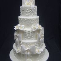 Ivory Elegance 5 tier 14-12-10-8-6 all fondant with gumpaste bows and roses. Royal Icing accents. Enjoy!